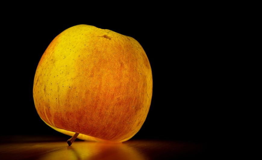 Yellow Apple on Black Background with Dramatic Lighting