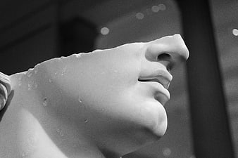 Close-up of classical marble statue face in black and white