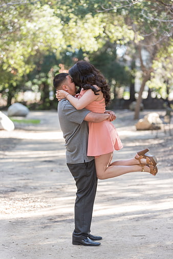 Romantic couple kissing outdoors in park