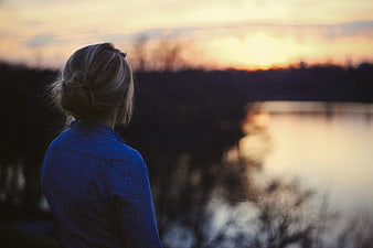 Woman Watching Sunset Over Lake