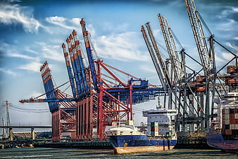 Container Ship Docked at Busy Port Terminal with Large Cranes