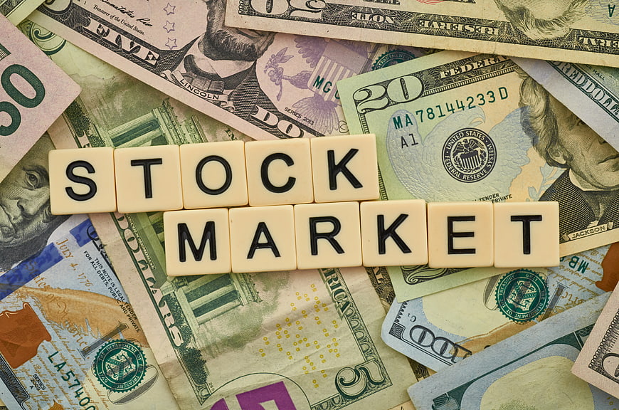 Stock Market Concept with Scrabble Tiles on US Dollar Bills