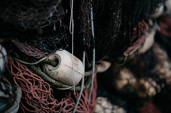 Close-up of weathered fishing nets and buoy