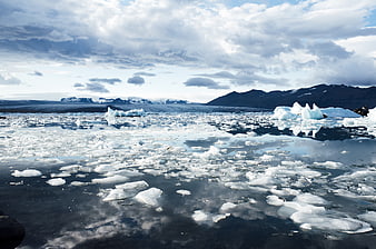 Icelandic Glacier Lagoon with Floating Icebergs and Mountains