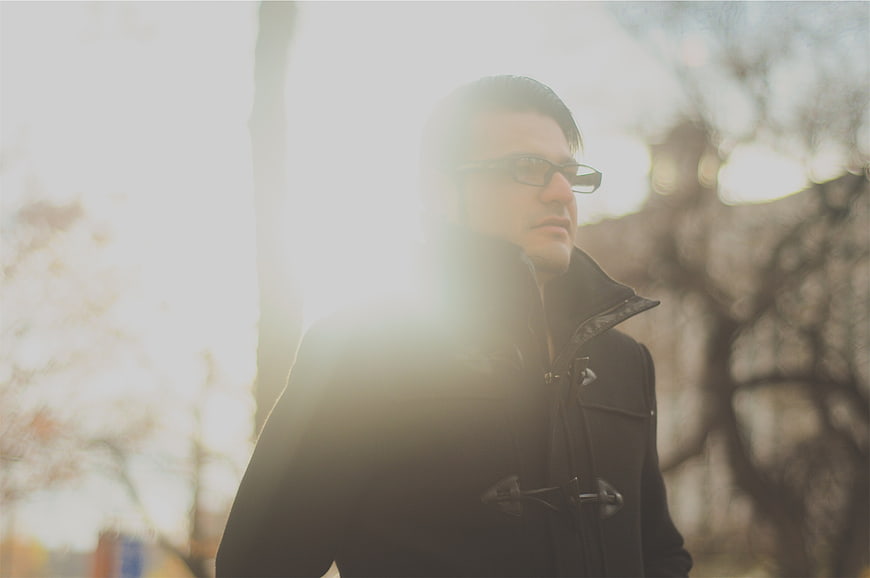 Man in Duffle Coat and Glasses in Bright Sunlight
