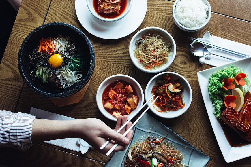 Overhead view of traditional Korean bibimbap and side dishes