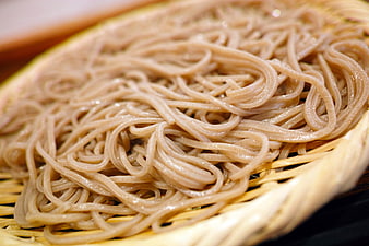 Close-up of fresh soba noodles in a woven bamboo basket