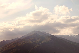 Majestic Mountain Peaks Under Dramatic Cloudy Sky