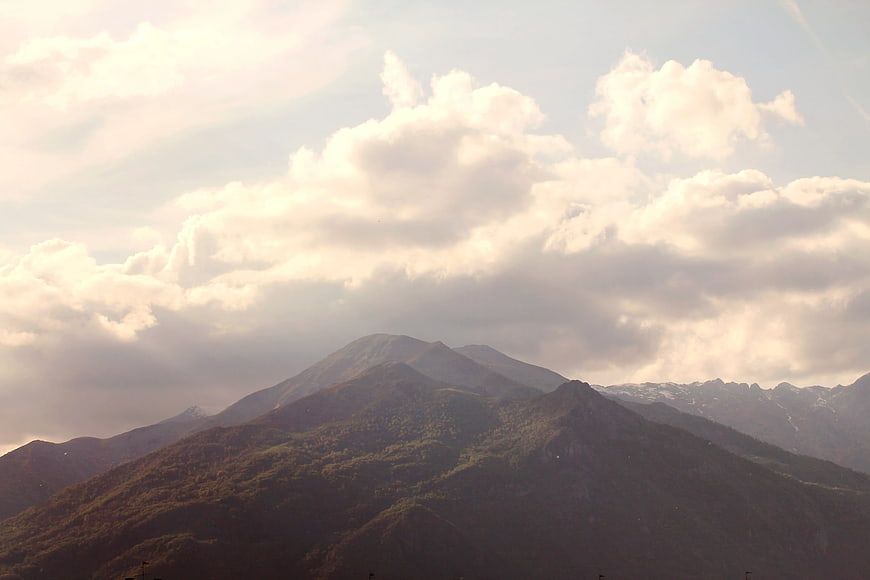 Majestic Mountain Peaks Under Dramatic Cloudy Sky