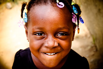 Close-up portrait of smiling African girl with colorful beads