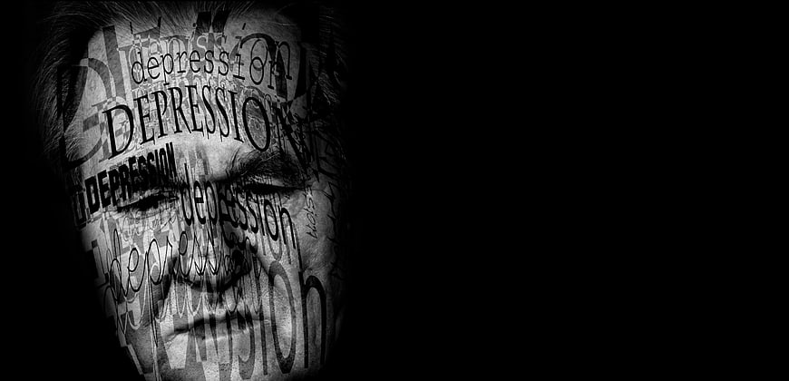 Man's face covered in depression text on black background