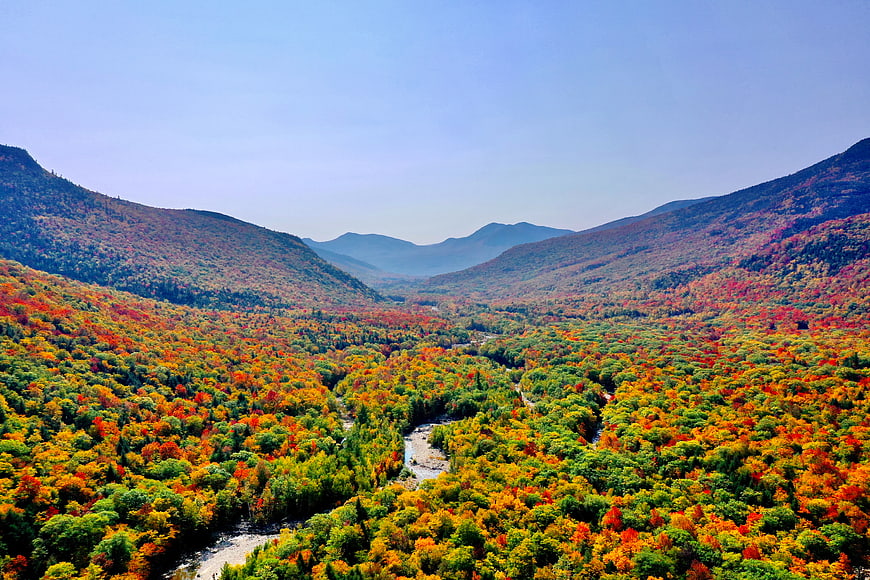 Aerial View of Colorful Autumn Forest Valley with River