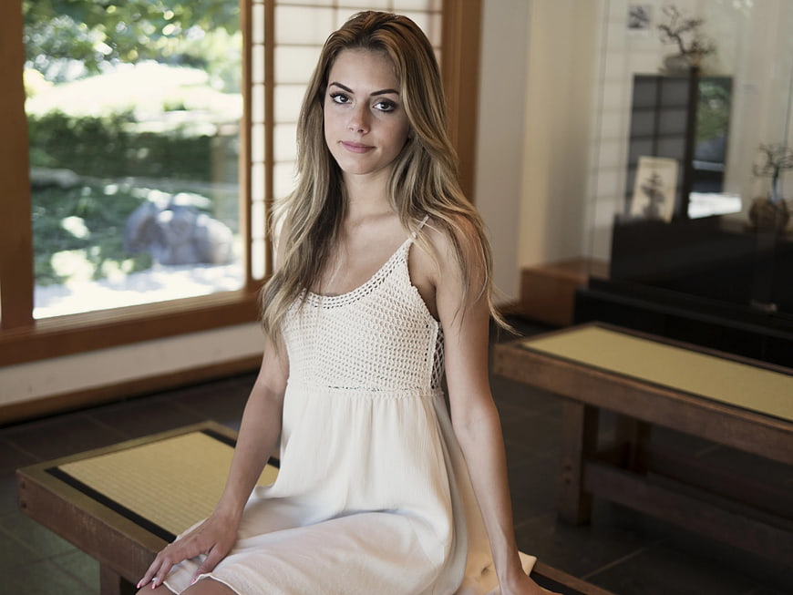 Woman in White Dress Sitting on Wooden Bench