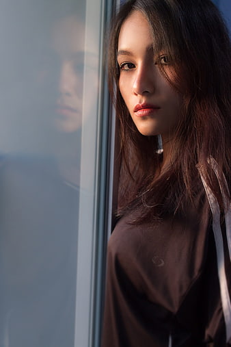 Moody Portrait of Woman by Window with Reflection