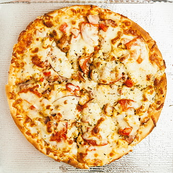 Top View of Homemade Chicken and Tomato Pizza on White Wood