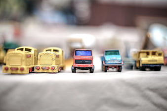 Vintage toy trucks lined up with shallow depth of field
