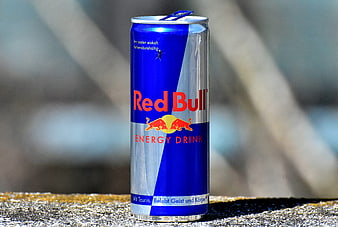 Open Red Bull Energy Drink Can on Concrete Surface