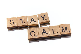 Wooden Scrabble Tiles Spelling Stay Calm on White Background