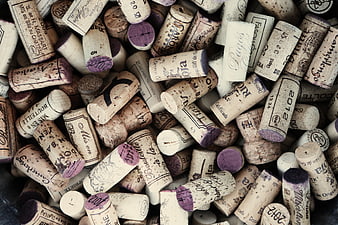 Collection of used wine corks with vintage labels