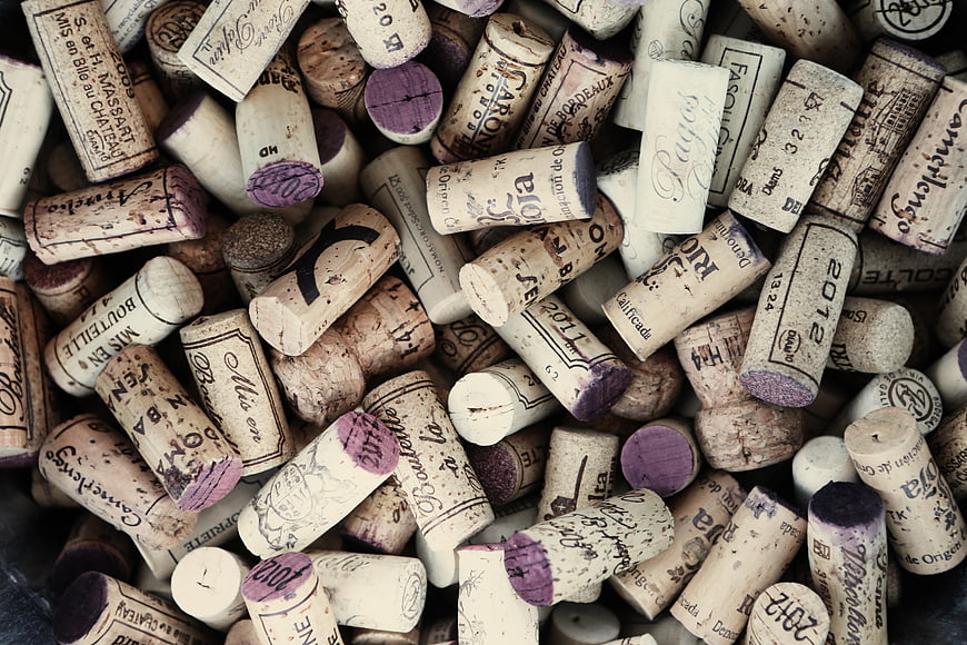 Collection of used wine corks with vintage labels