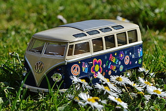 Vintage VW Camper Van Model in Meadow with Daisies