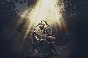 Pieta sculpture with dramatic divine light rays in dark forest setting