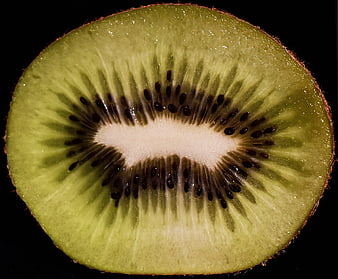 Close-up of sliced kiwi fruit on black background