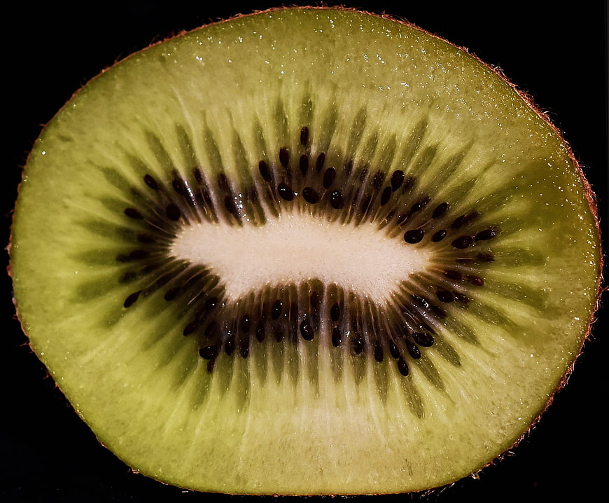 Close-up of sliced kiwi fruit on black background