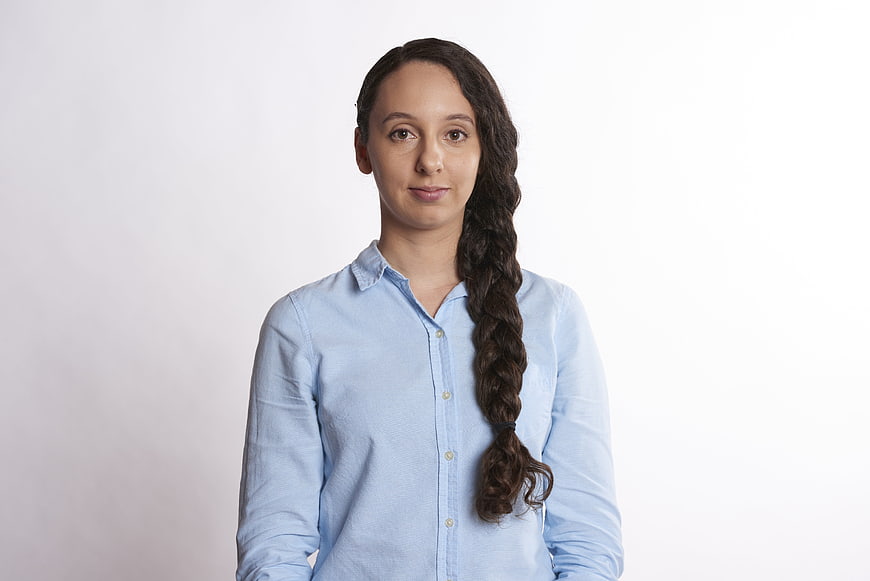 Professional Portrait Of Businesswoman With Long Braid Wearing Light Blue Shirt