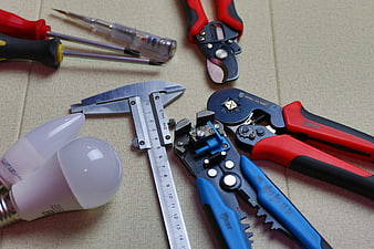 Electrician Tools And LED Bulbs On Beige Fabric Surface