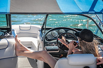 Woman Driving Speedboat with Legs Up on Sunny Day