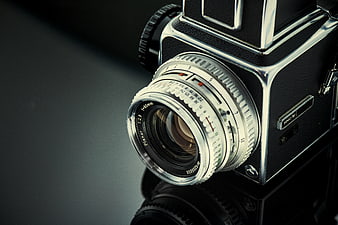 Close-up of vintage Hasselblad camera lens on dark background