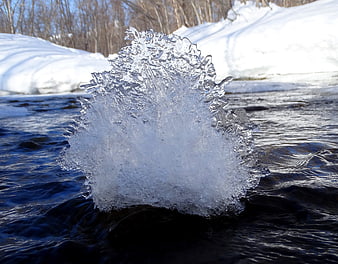 Frozen Ice Spike in Winter River Stream