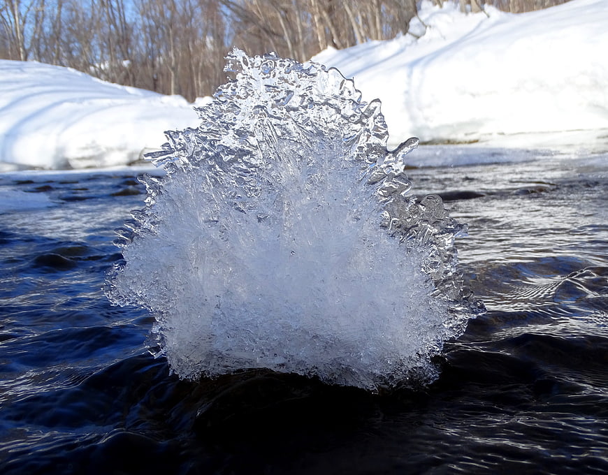 Frozen Ice Spike in Winter River Stream