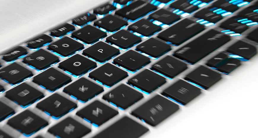 Close-up of Backlit Laptop Keyboard with Blue LED Lights