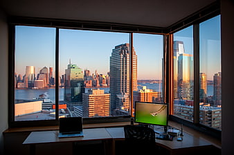 Modern Home Office with City Skyline View at Sunset
