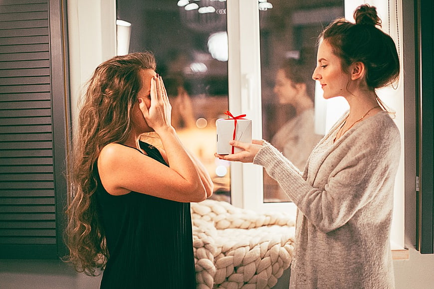 Woman Receiving Gift Surprise Indoors