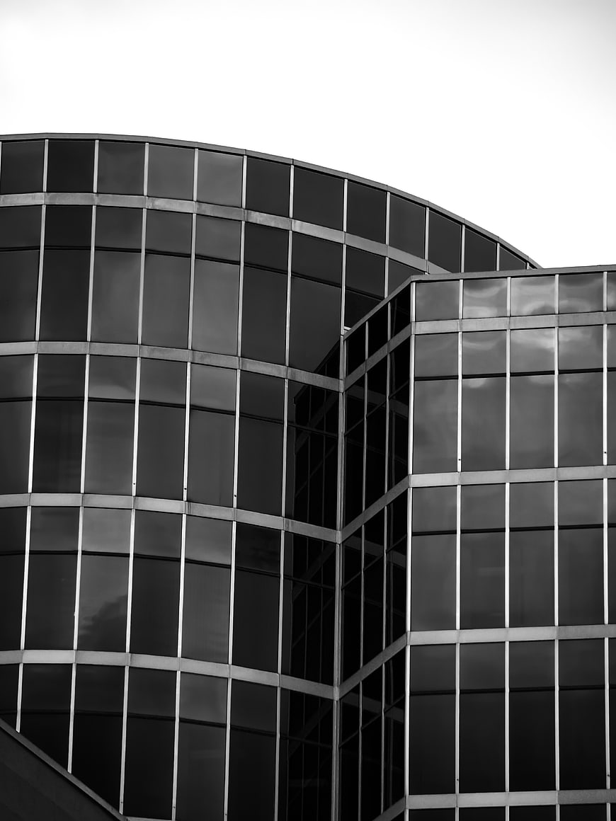 Black and white modern curved glass office building facade