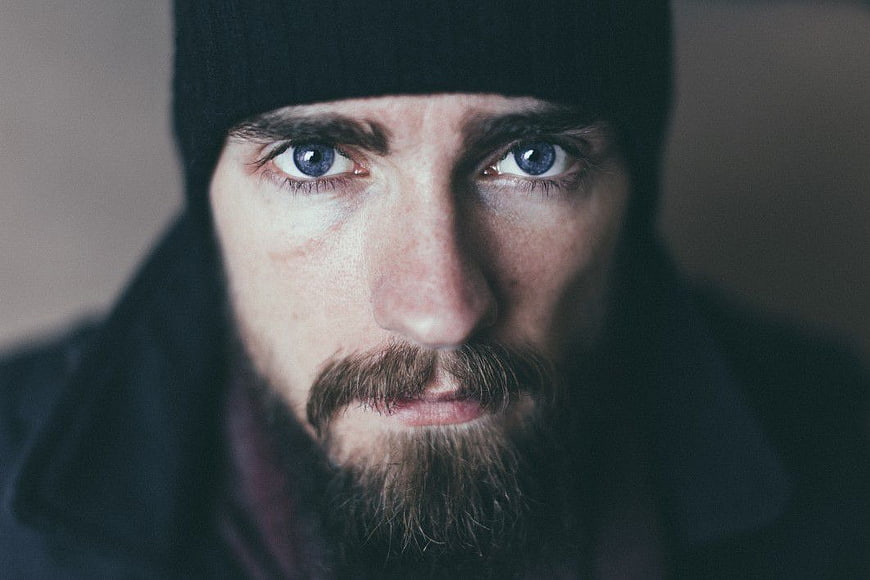 Intense Close-Up Portrait of Man with Blue Eyes and Beanie