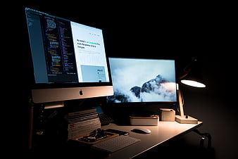 Modern dual monitor workspace with code and design
