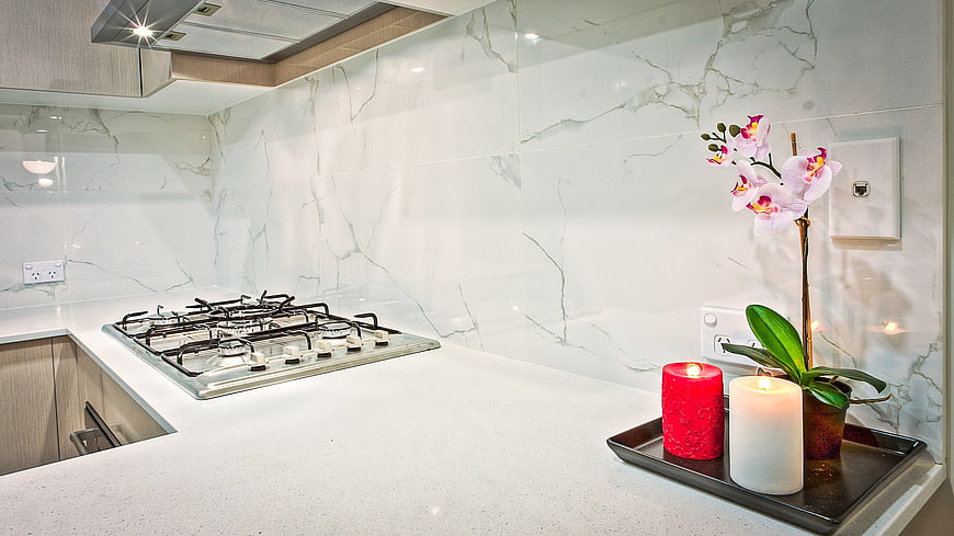 Modern kitchen interior with marble backsplash and gas cooktop