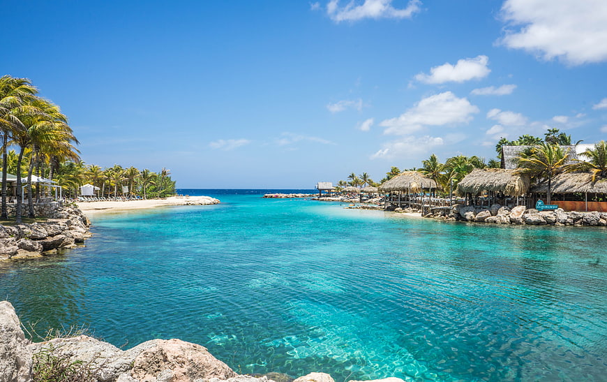 Tropical Lagoon with Turquoise Water and Thatched Beach Cabanas