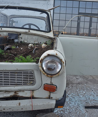Rusty vintage Trabant car repurposed as planter