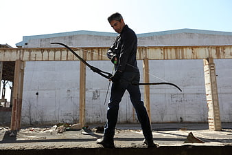 Man with Recurve Bow in Abandoned Industrial Ruins