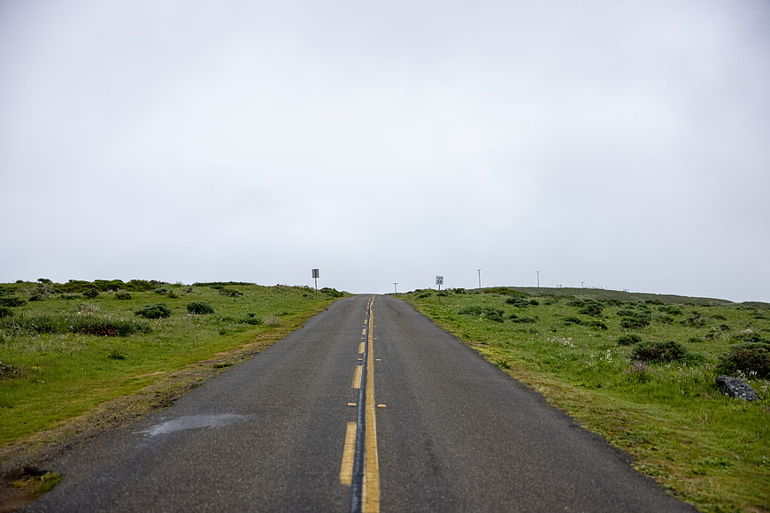 Empty Rural Road Stretching to Horizon Under Overcast Sky