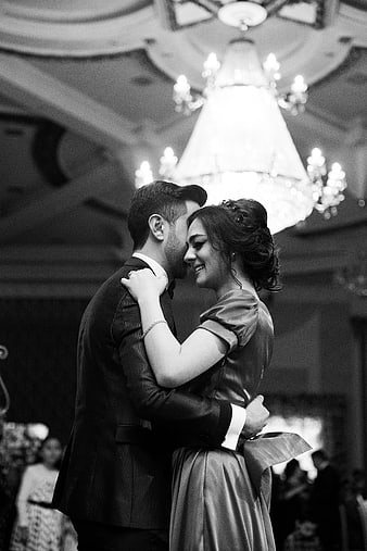 Romantic Black and White Wedding Couple Dancing Under Chandelier