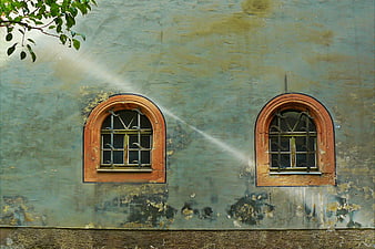 Two Arched Windows on Weathered Blue Wall