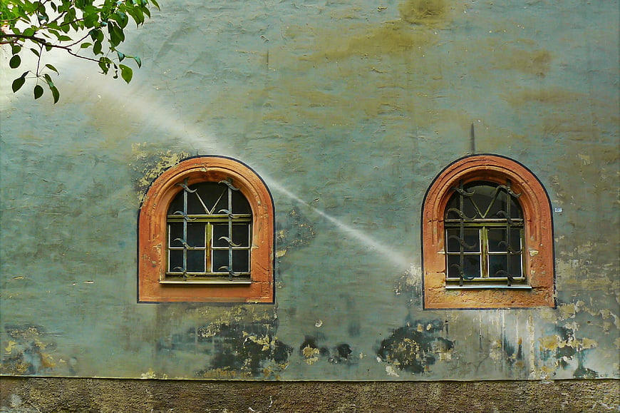 Two Arched Windows on Weathered Blue Wall