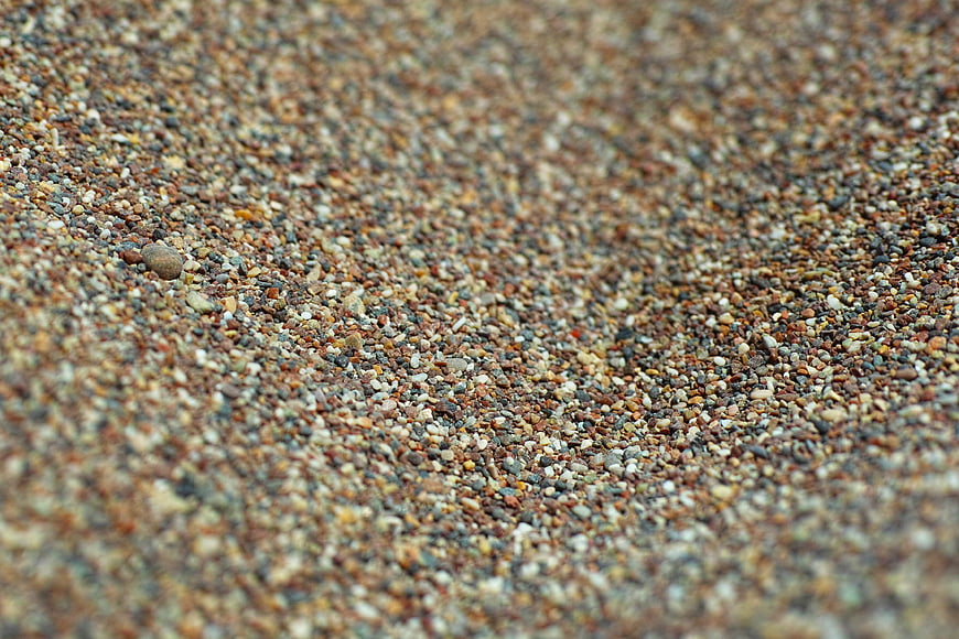Close-up texture of multicolored gravel and small stones on a beach