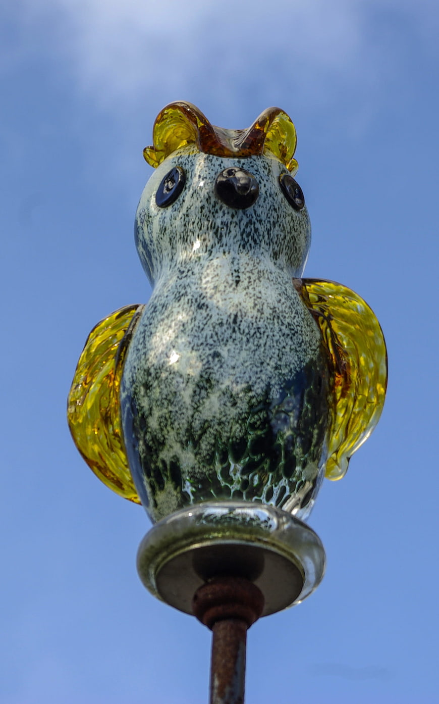 Glass Owl Sculpture Against Blue Sky